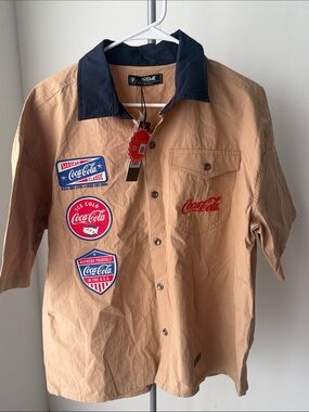 Coca Cola Tan Short Sleeve Button-Down Shirt with Navy Collar and Red Logos